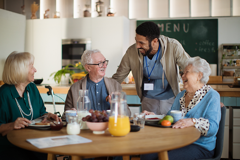 Group of cheerful seniors enjoying breakfast