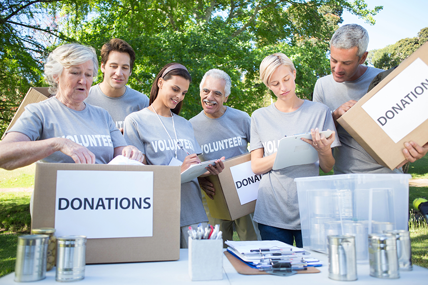 happy-volunteer-family-holding-donation-boxes