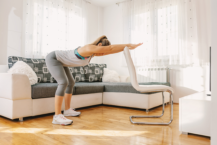 Muscular sportswoman in shape doing fitness exercises 